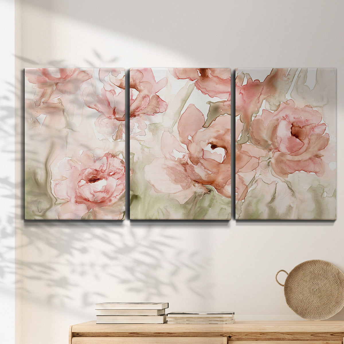 Three-panel canvas wall art featuring spring floral blossoms in bloom, displayed in a minimalist living room above a console table.