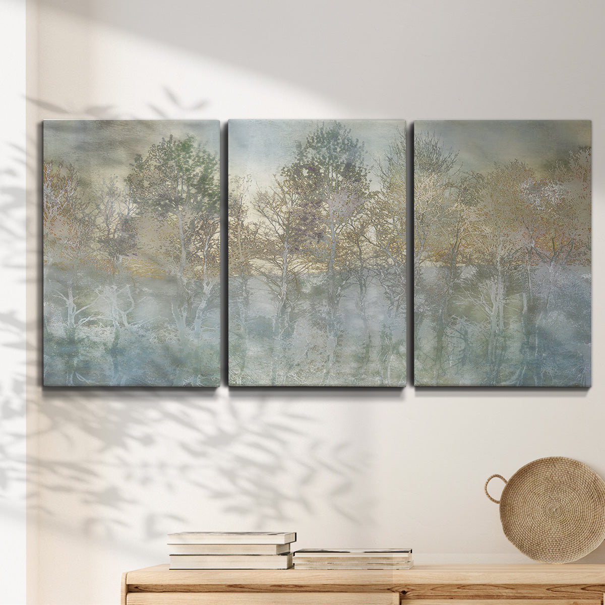 Three-panel canvas wall art featuring abstract river reflections, displayed in a minimalist living room above a console table.