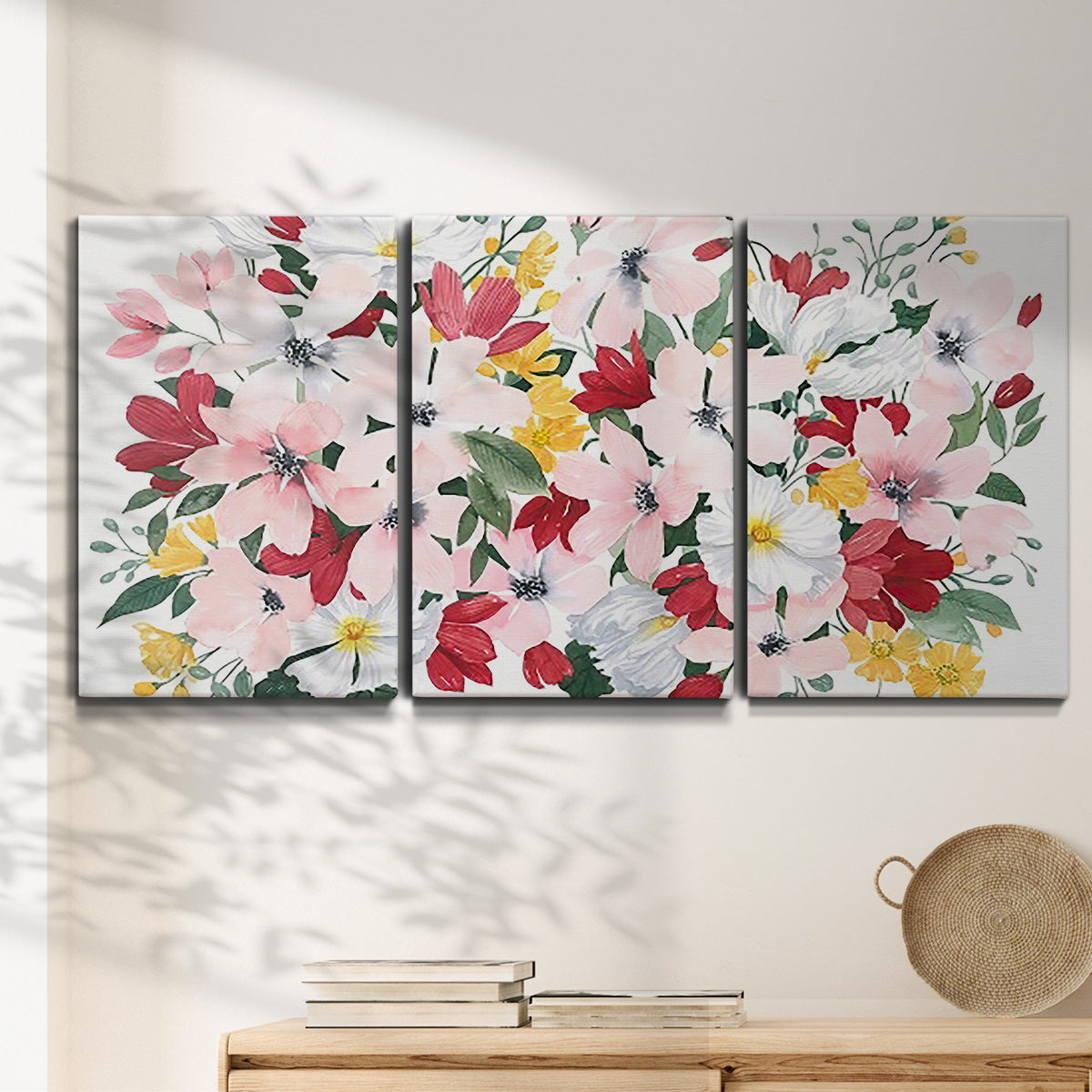 Three-panel canvas wall art featuring joyful spring floral composition, displayed in a minimalist living room above a console table.