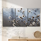 Three-panel canvas wall art featuring delicate spring blossoms on branches, displayed in a minimalist living room above a console table.