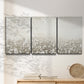 Three-panel canvas wall art featuring dark textured abstract mist, displayed in a minimalist living room above a console table.
