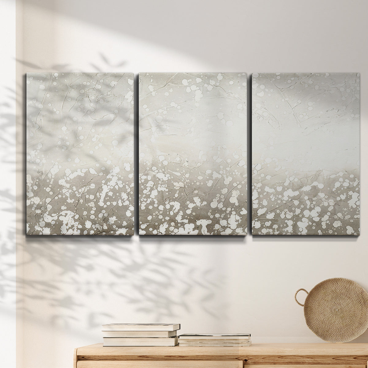 Three-panel canvas wall art featuring dark textured abstract mist, displayed in a minimalist living room above a console table.