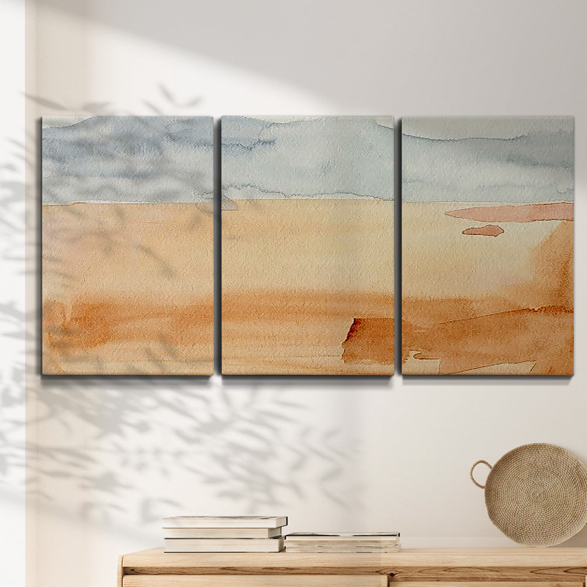 Three-panel canvas wall art featuring minimal horizon with soft blue tones, displayed in a minimalist living room above a console table.