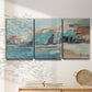 Three-panel canvas wall art featuring coastal shoreline with soft waves, displayed in a minimalist living room above a console table.