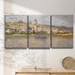 Three-panel canvas wall art featuring village overlooking river valley, displayed in a minimalist living room above a console table.