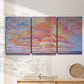 Three-panel canvas wall art featuring peaceful tropical inspired landscape, displayed in a minimalist living room above a console table.