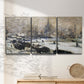 Three-panel canvas wall art featuring snowy village road in winter, displayed in a minimalist living room above a console table.