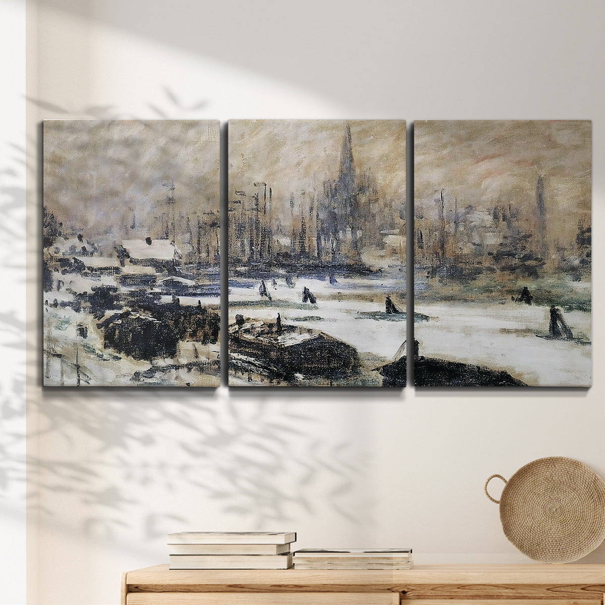 Three-panel canvas wall art featuring snowy village road in winter, displayed in a minimalist living room above a console table.
