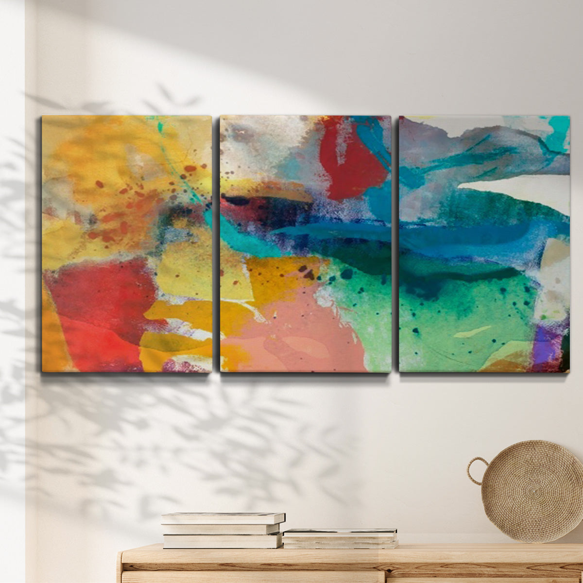 Three-panel canvas wall art featuring layered abstract observational color blocks, displayed in a minimalist living room above a console table.