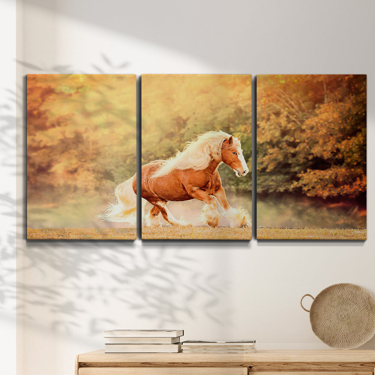 Three-panel canvas wall art featuring running horses captured in motion, displayed in a minimalist living room above a console table.
