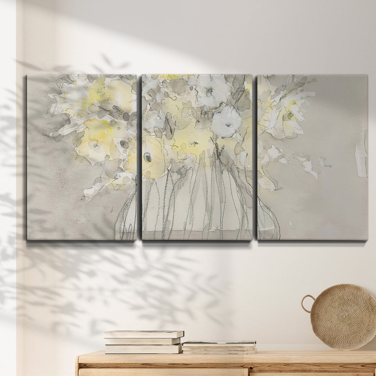 Three-panel canvas wall art featuring vintage floral abstract composition, displayed in a minimalist living room above a console table.