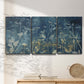 Three-panel canvas wall art featuring dark abstract with rich tonal depth, displayed in a minimalist living room above a console table.