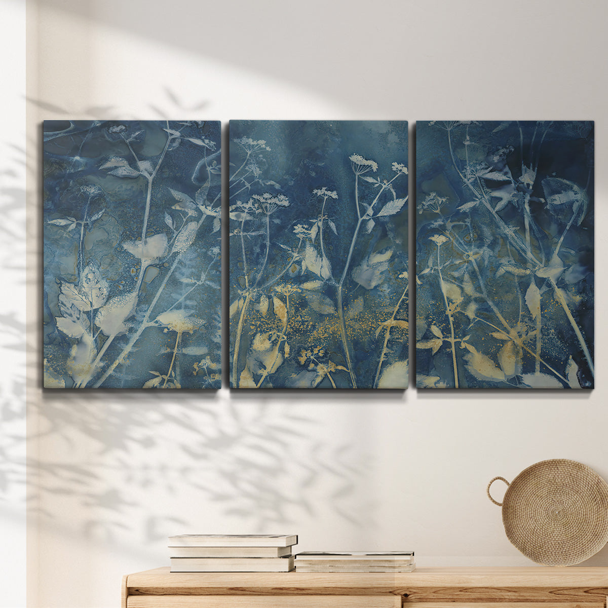 Three-panel canvas wall art featuring dark abstract with rich tonal depth, displayed in a minimalist living room above a console table.