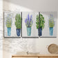 Three-panel canvas wall art featuring minimal monochrome abstract forms, displayed in a minimalist living room above a console table.
