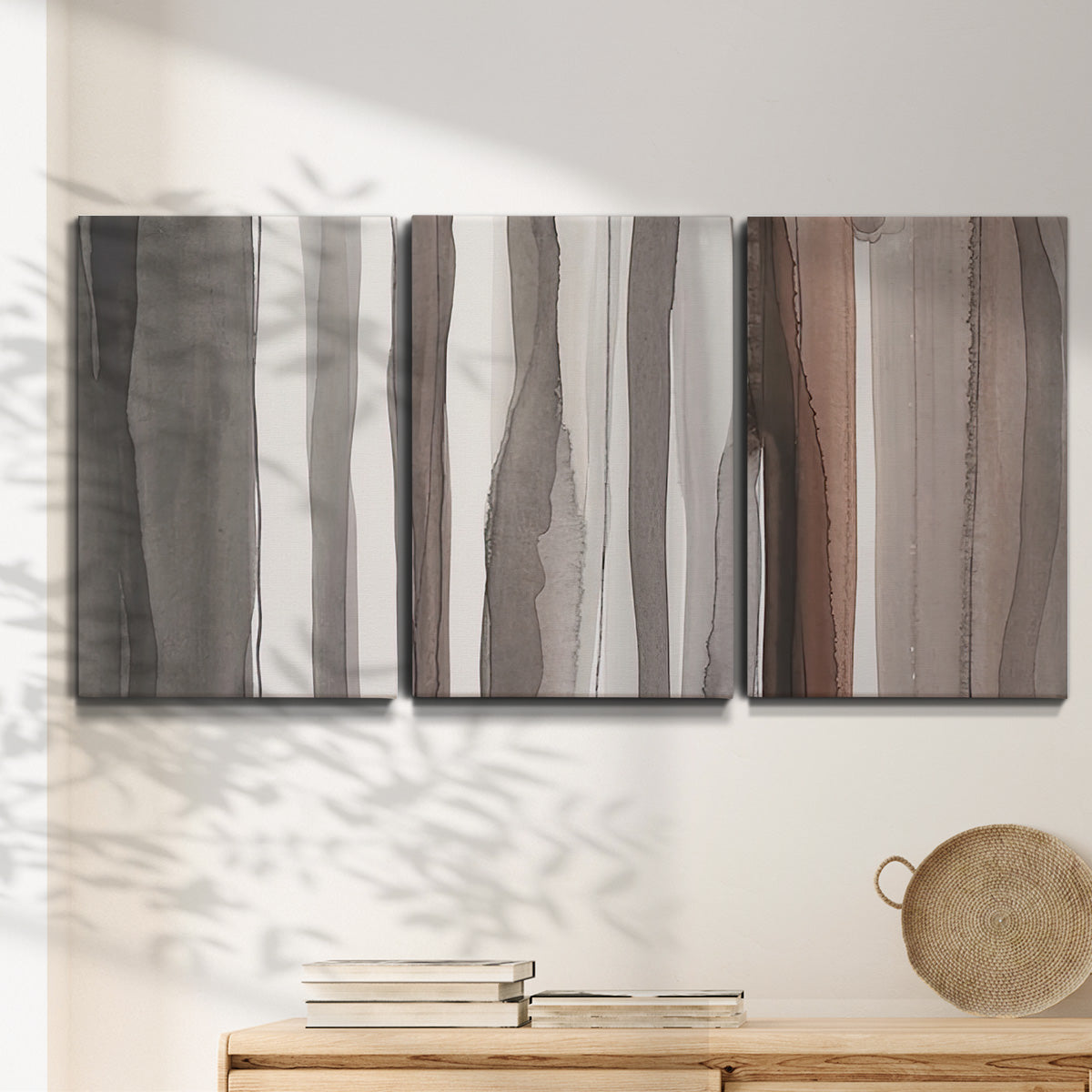 Three-panel canvas wall art featuring riverbank landscape with reflections, displayed in a minimalist living room above a console table.