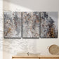 Three-panel canvas wall art featuring wooded trail through forest, displayed in a minimalist living room above a console table.