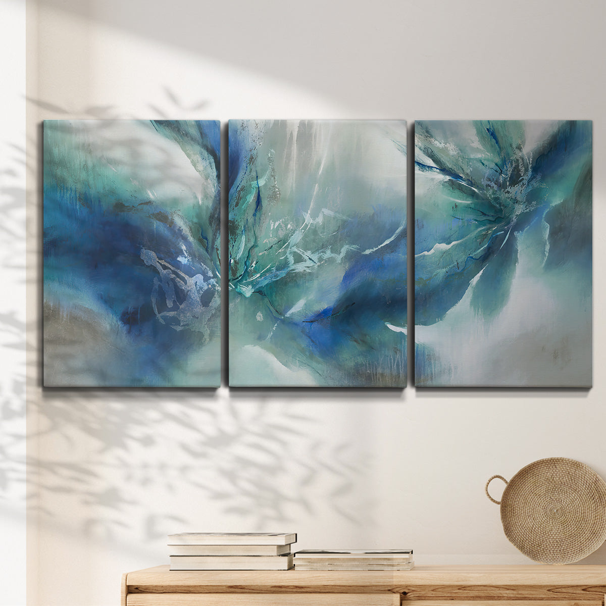 Three-panel canvas wall art featuring subtle abstract light flicker composition, displayed in a minimalist living room above a console table.