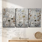 Three-panel canvas wall art featuring misty wildflower meadow landscape, displayed in a minimalist living room above a console table.