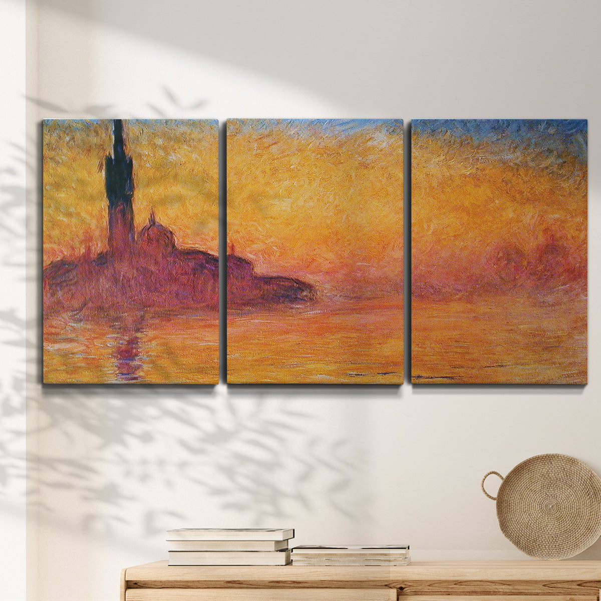 Three-panel canvas wall art featuring venetian church at twilight, displayed in a minimalist living room above a console table.