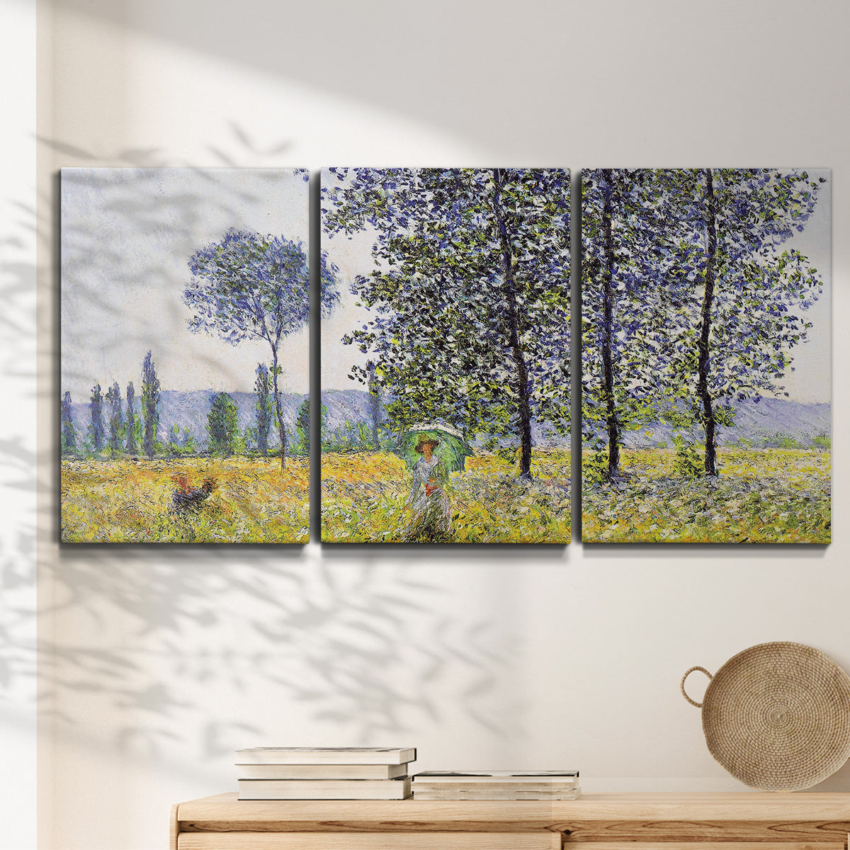 Three-panel canvas wall art featuring sunlight filtering through tall poplars, displayed in a minimalist living room above a console table.