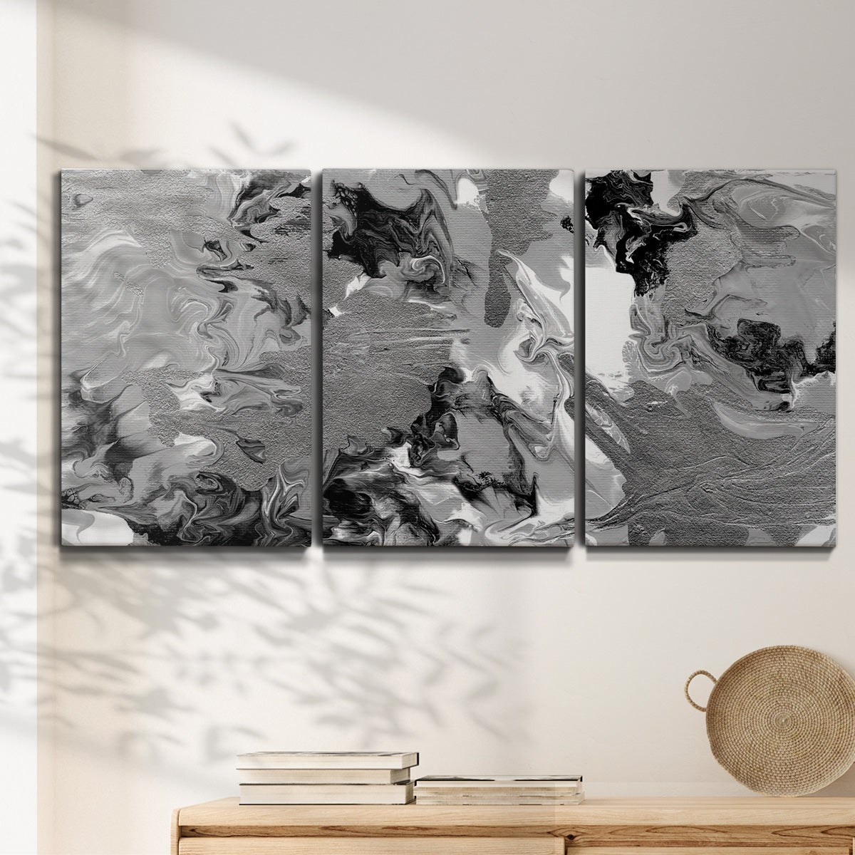 Three-panel canvas wall art featuring abstract marble texture composition, displayed in a minimalist living room above a console table.