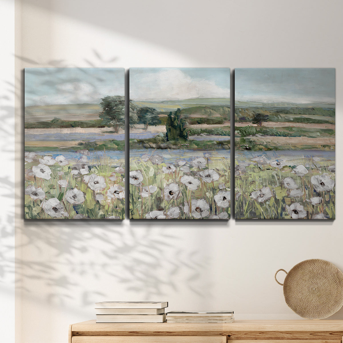 Three-panel canvas wall art featuring vintage poppy filled valley, displayed in a minimalist living room above a console table.