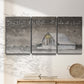 Three-panel canvas wall art featuring rustic winter holiday text art, displayed in a minimalist living room above a console table.