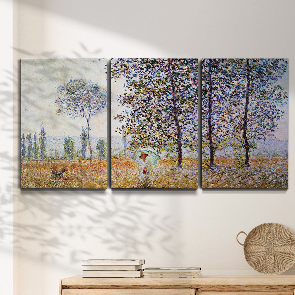 Three-panel canvas wall art featuring three poplar trees beside water, displayed in a minimalist living room above a console table.