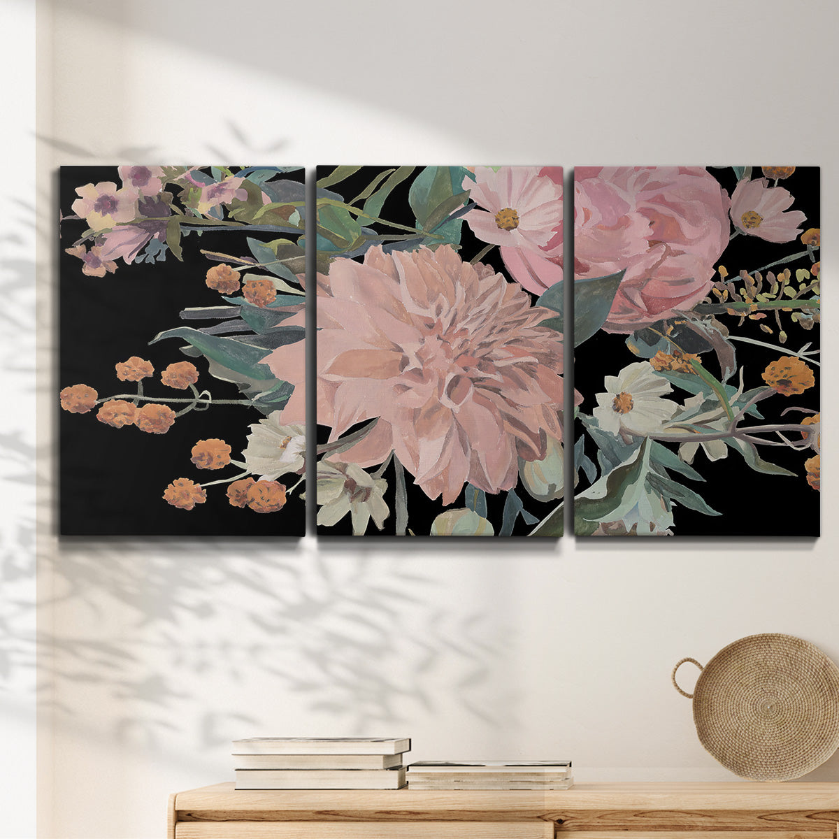 Three-panel canvas wall art featuring dark floral night blossoms, displayed in a minimalist living room above a console table.