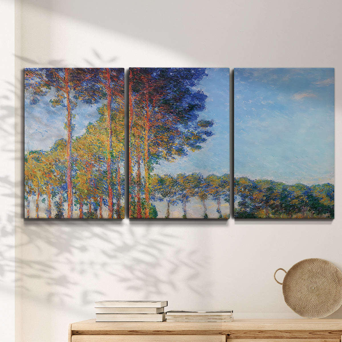 Three-panel canvas wall art featuring autumn poplar trees along river, displayed in a minimalist living room above a console table.