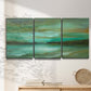 Three-panel canvas wall art featuring hidden coastal cove landscape, displayed in a minimalist living room above a console table.