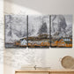 Three-panel canvas wall art featuring winter village street photography, displayed in a minimalist living room above a console table.