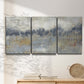 Three-panel canvas wall art featuring soft grey abstract horizon, displayed in a minimalist living room above a console table.