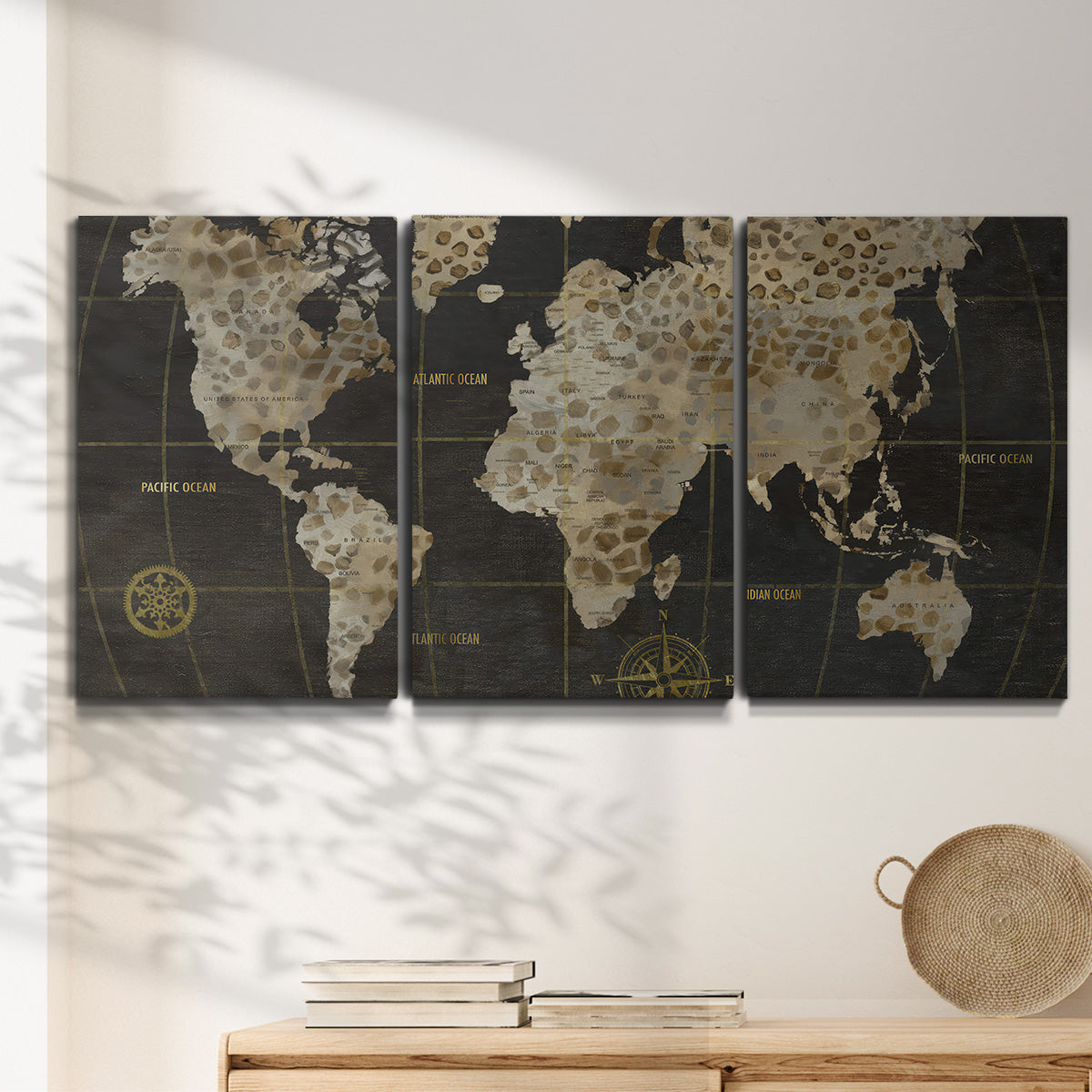 Three-panel canvas wall art featuring illustrated safari world map, displayed in a minimalist living room above a console table.