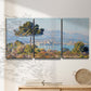 Three-panel canvas wall art featuring coastal town viewed from hillside, displayed in a minimalist living room above a console table.
