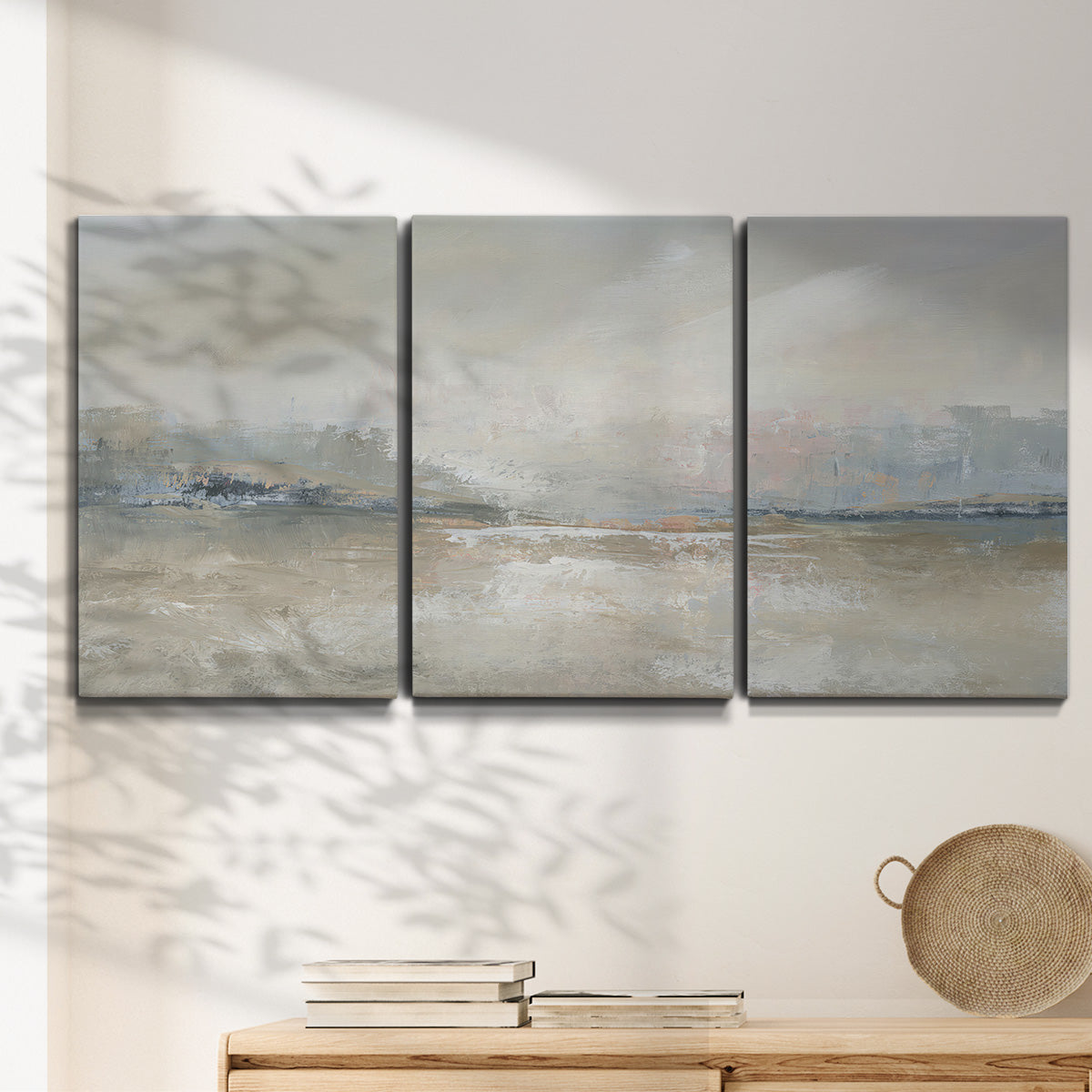 Three-panel canvas wall art featuring soft abstract horizon haze, displayed in a minimalist living room above a console table.