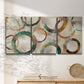 Three-panel canvas wall art featuring geometric circular abstract design, displayed in a minimalist living room above a console table.