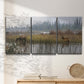 Three-panel canvas wall art featuring wildlife walking through open field, displayed in a minimalist living room above a console table.