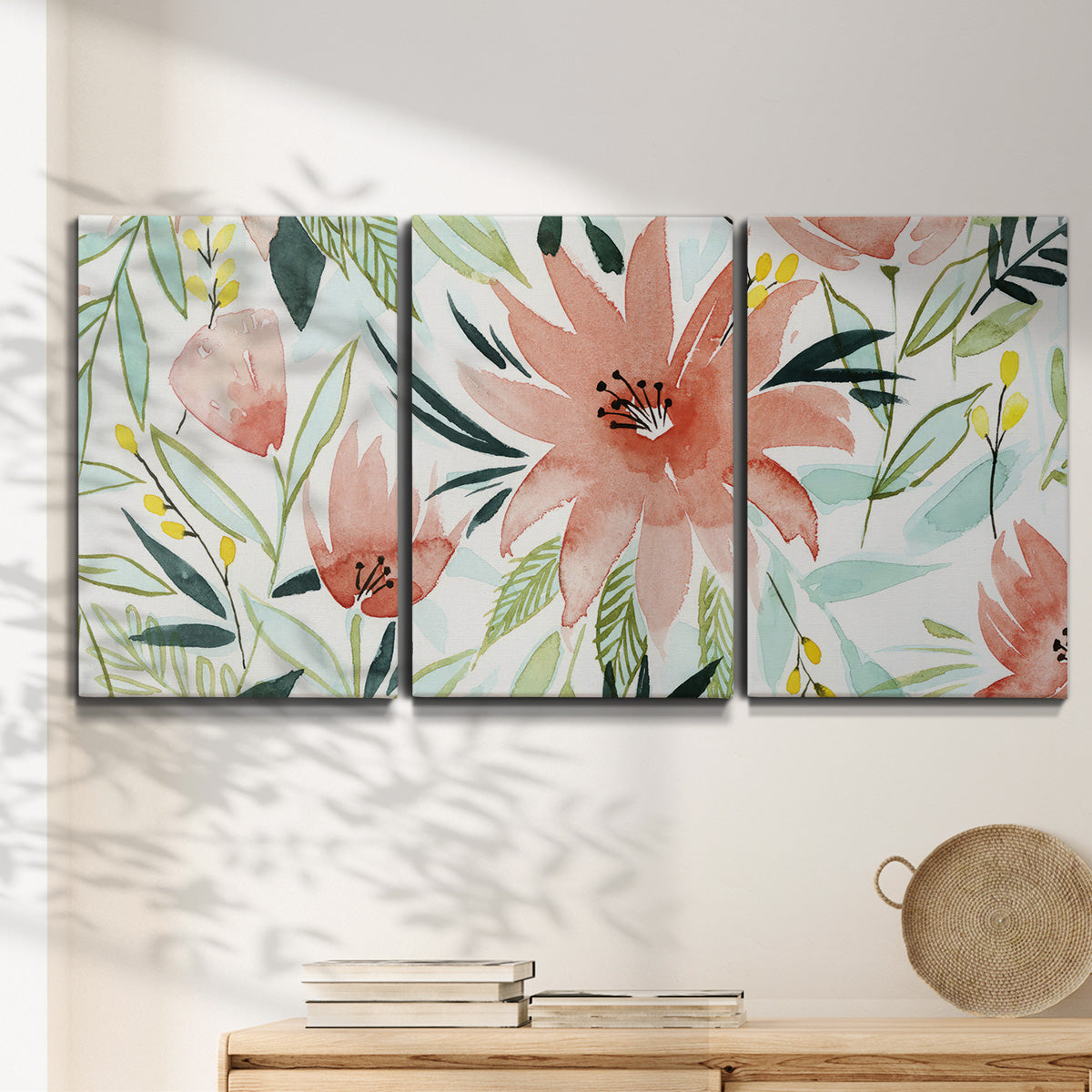 Three-panel canvas wall art featuring tropical botanical collage, displayed in a minimalist living room above a console table.