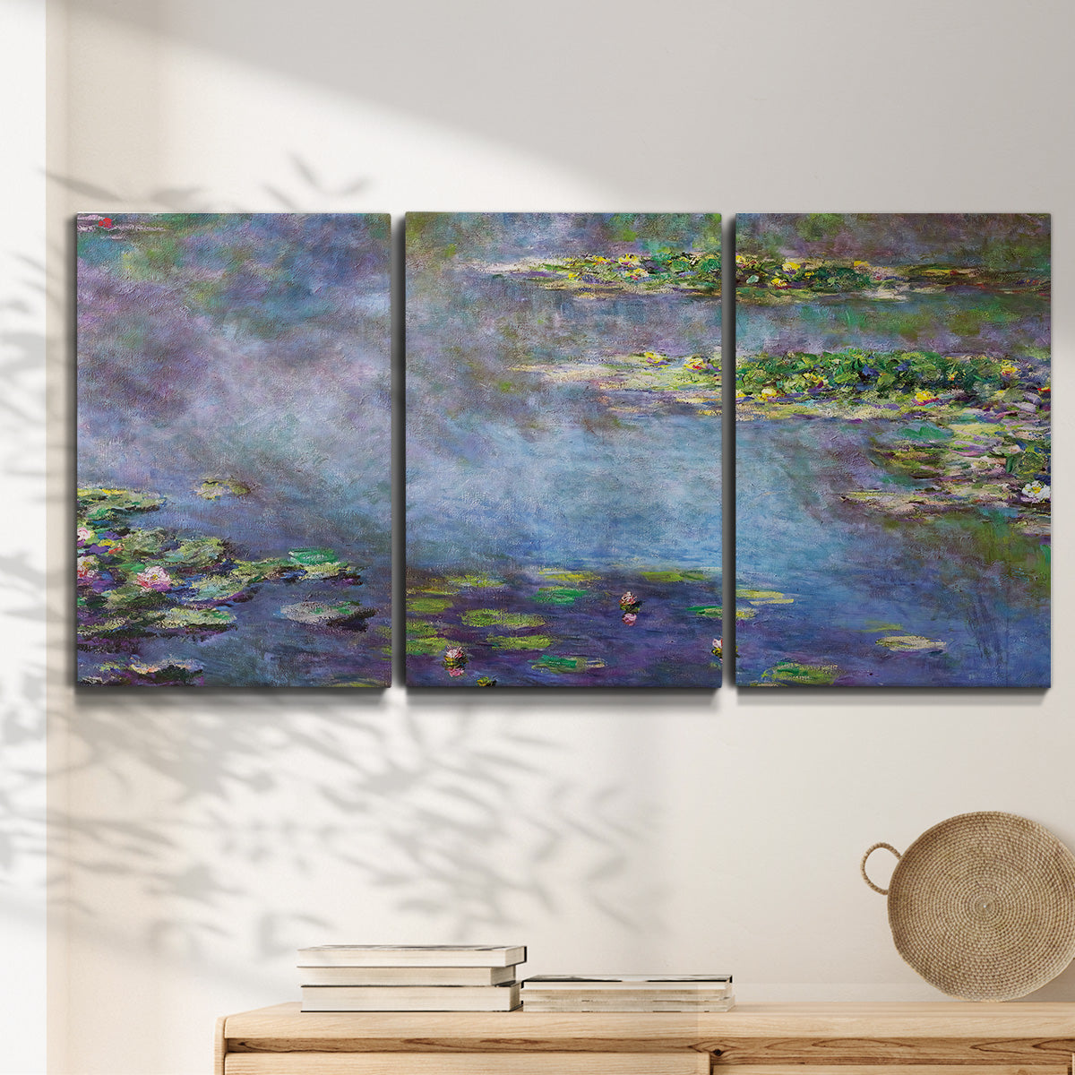 Three-panel canvas wall art featuring water lilies emerging through mist, displayed in a minimalist living room above a console table.