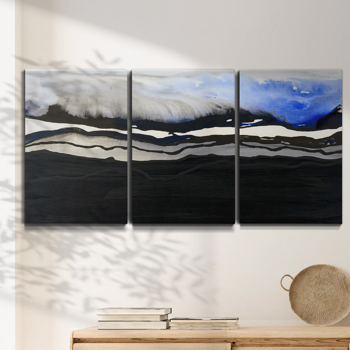 Three-panel canvas wall art featuring abstract passage of time composition, displayed in a minimalist living room above a console table.