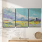Three-panel canvas wall art featuring open landscape suggesting distant journey, displayed in a minimalist living room above a console table.