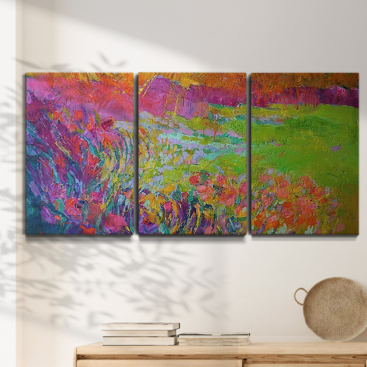 Three-panel canvas wall art featuring abstract meadow inspired color fields, displayed in a minimalist living room above a console table.