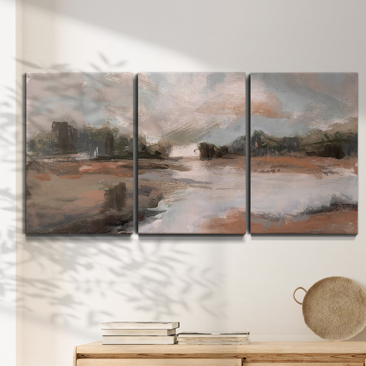 Three-panel canvas wall art featuring quiet pond with soft reflections, displayed in a minimalist living room above a console table.