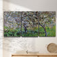 Three-panel canvas wall art featuring apple trees blooming beside water, displayed in a minimalist living room above a console table.