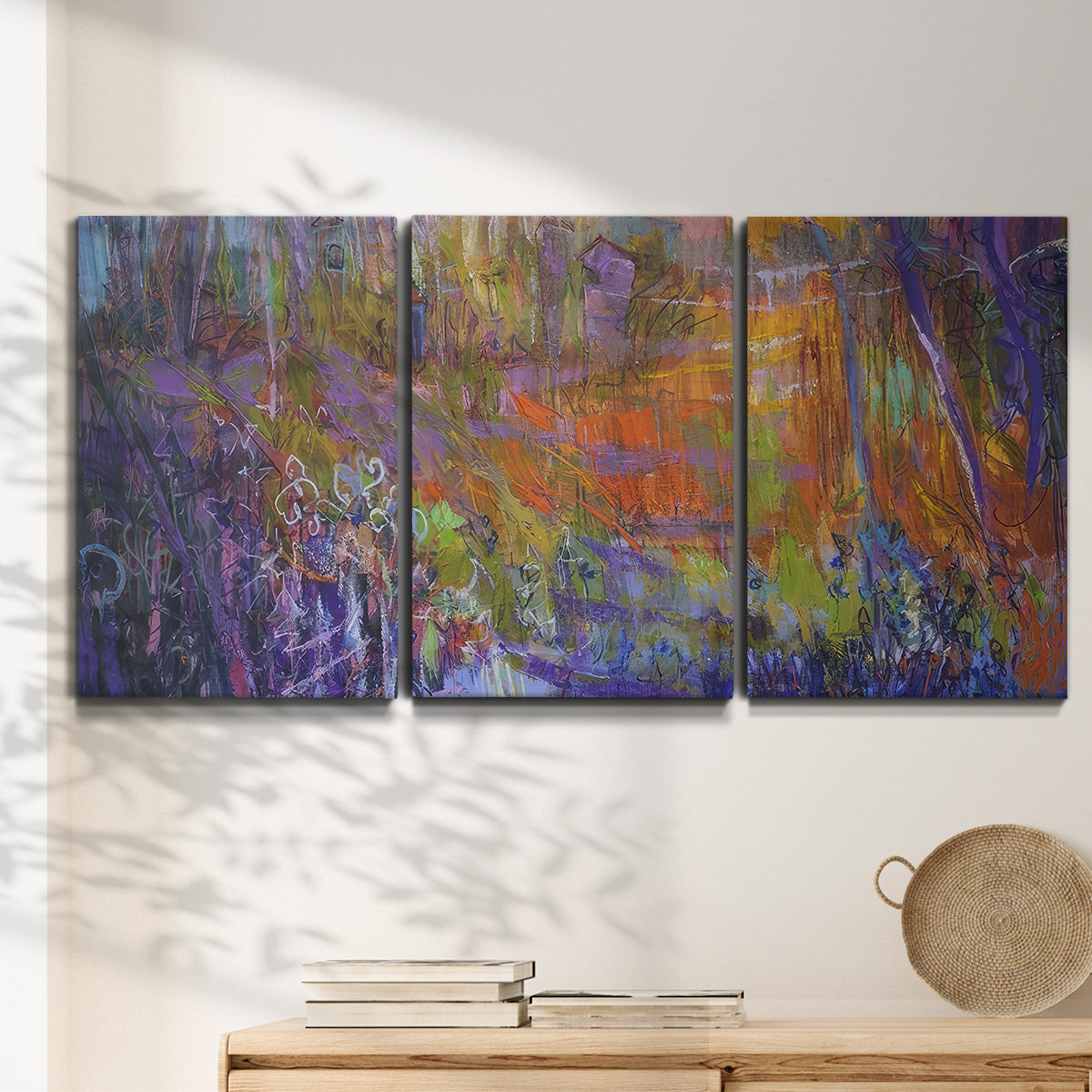 Three-panel canvas wall art featuring abstract rainfall with butterfly forms, displayed in a minimalist living room above a console table.