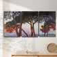 Three-panel canvas wall art featuring sunlit pines along mediterranean coast, displayed in a minimalist living room above a console table.