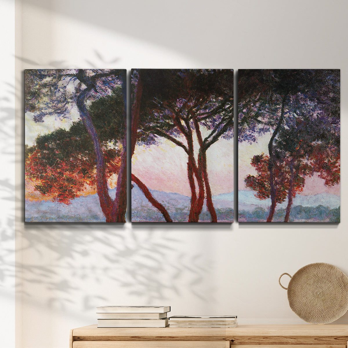Three-panel canvas wall art featuring sunlit pines along mediterranean coast, displayed in a minimalist living room above a console table.