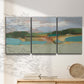 Three-panel canvas wall art featuring wide open landscape under midday light, displayed in a minimalist living room above a console table.