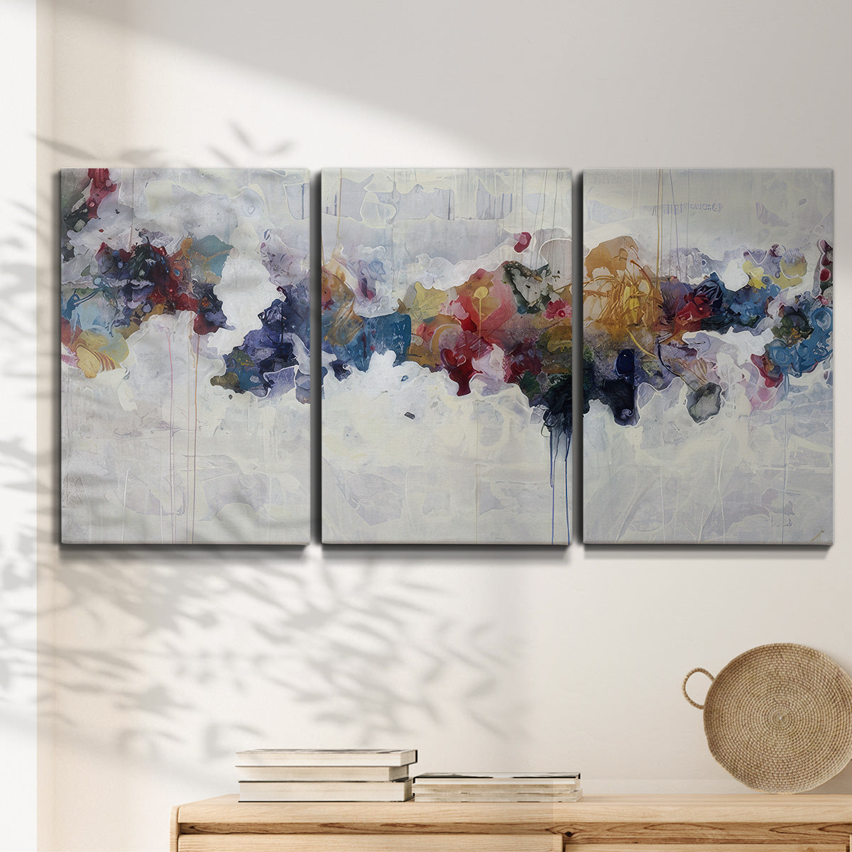 Three-panel canvas wall art featuring abstract water inspired composition, displayed in a minimalist living room above a console table.